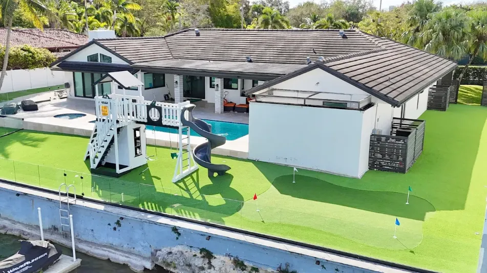 Luxury Houston backyard with putting green, playground and pool installed by First Class Turf