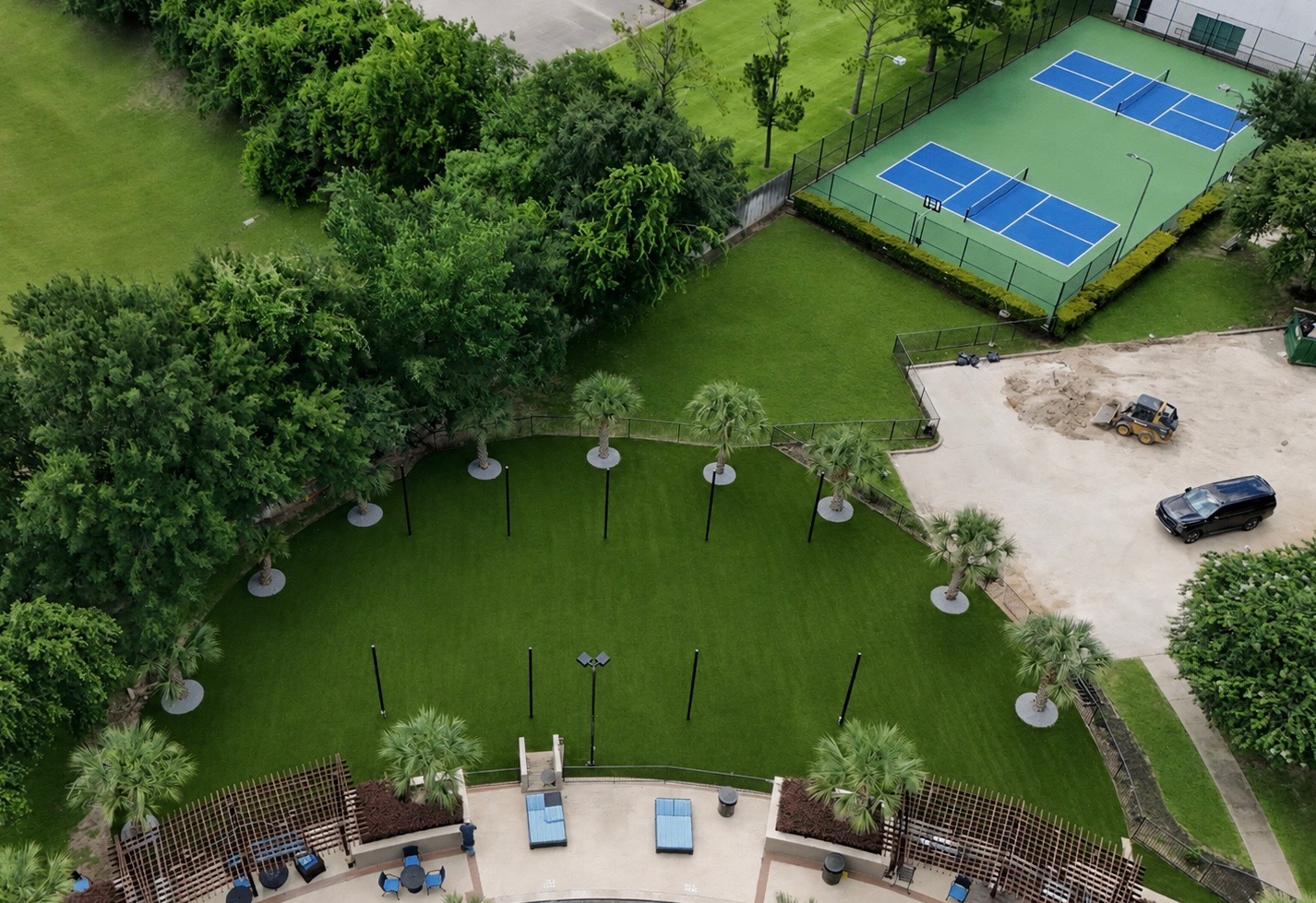 Aerial view of commercial amenity lawn with artificial turf and pickleball courts